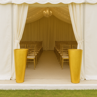 Pair of tall oversized gilt vases with tapered cylindrical shape and textured gold finish.
