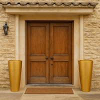 Pair of tall oversized gilt vases with tapered cylindrical shape and textured gold finish.