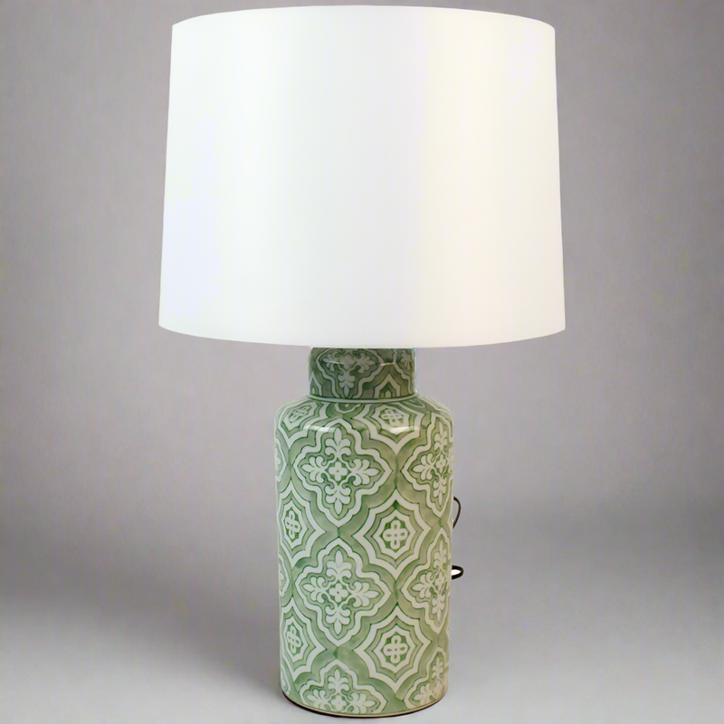 A beautiful pale green ceramic lamp base with a large white linen shade, a bright, clean lamp to add a striking glow to any room.&nbsp; Ceramic lamps have been an important part of Engliah country homes for years and you can now place them in your town home. This particular light is decorated in a beautiful pale green with an oriental pattern.&nbsp; The addition of the substantial white fabric shade, you'll get a great light from this lamp.