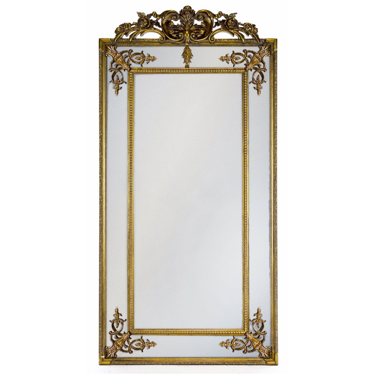 Tall, elegant paneled mirror in gilt wood frame with baroque motifs to the corners.