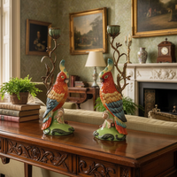 Colorful parrot candlesticks with branch details on wooden table in vintage living room