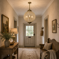 Globe light in a cottage style hall, with console table and wooden settle. 