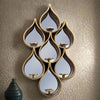 Tall teardrop-shaped mirror with pierced Moroccan-style metal frame and candleholders