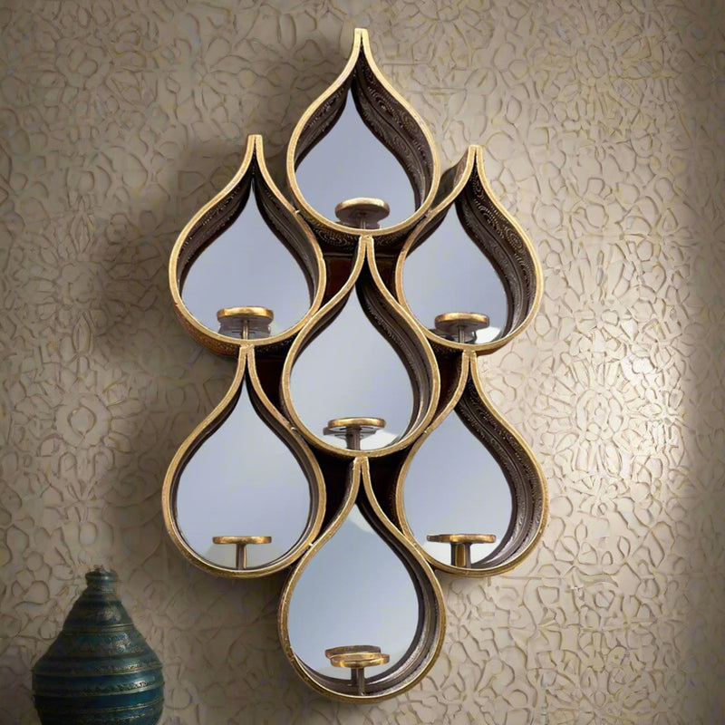 Tall teardrop-shaped mirror with pierced Moroccan-style metal frame and candleholders