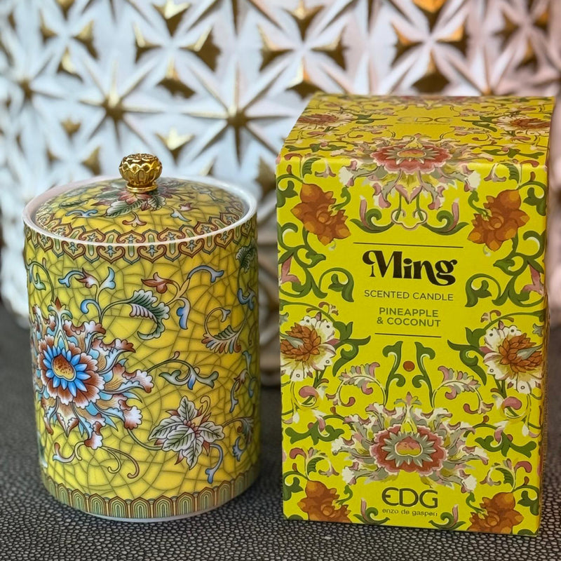 Handcrafted yellow ceramic scented candle jar with gold detailing and floral design, scented with Pineapple and Coconut.