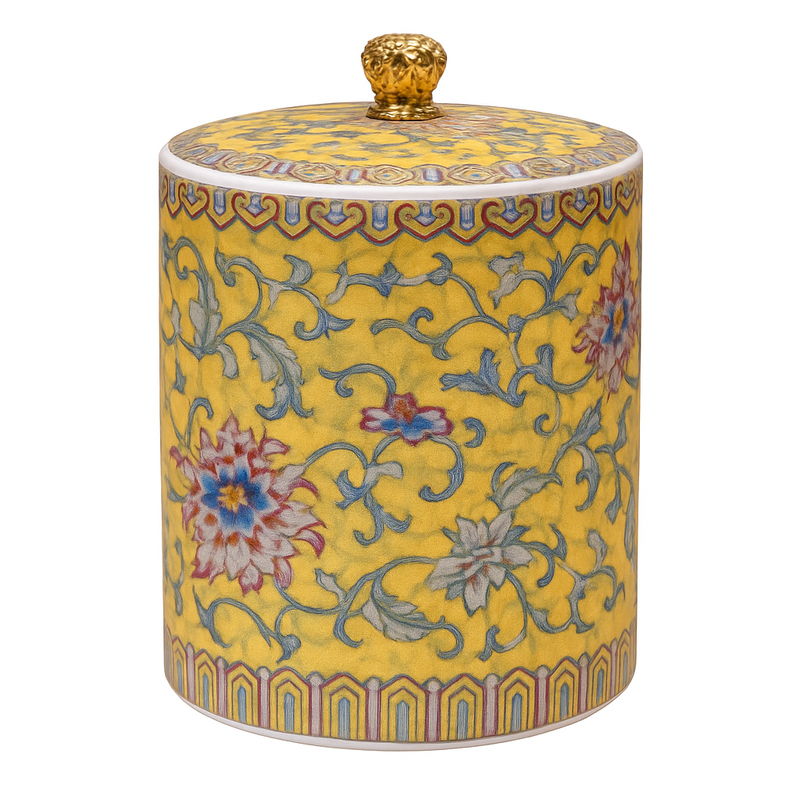 Handcrafted yellow ceramic scented candle jar with gold detailing and floral design, scented with Pineapple and Coconut.