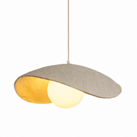 Textured plaster exterior of wave pendant light