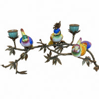 Decorative candleholder with three colourful porcelain birds, a bronze-style leafy branch and two porcelain candle cups.