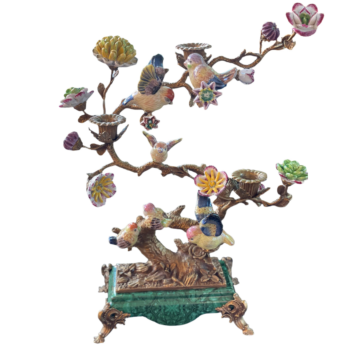 Bronze sculptured branches in this candelabra hold little porcelain birds and flowers and on the branches there are three bronze candleholders.&nbsp; A mixture of greens, pinks, yellow and blue, the colourful tree is set on a rectangular green porcelain base on small bronze feet. The most decorative candleholder would look stunning as a centrepiece or set on a beautiful piece of furniture to add interest and a luxurious touch to your interior. 