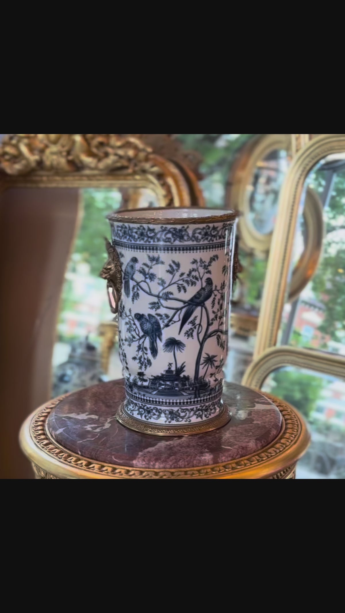 This exquisite Bronze Porcelain Decorative Vase is functional as it is decorative,

Handcrafted in superior blue and white porcelain, this delicately weighted vase features intricate bird and foliage motifs.&nbsp; Bold bronze lion head handle and detailed bronze accents reflect exceptional craftsmanship.&nbsp; The aged porcelain body is delicately hand-painted which adds to its opulent appeal.

Ideal for living rooms, entryways, or as a centerpiece, this handcrafted vase is designed for as a lasting beauty,