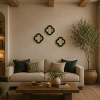 Small quatrefoil mirror with a luxurious gold beaded border in a gallery wall