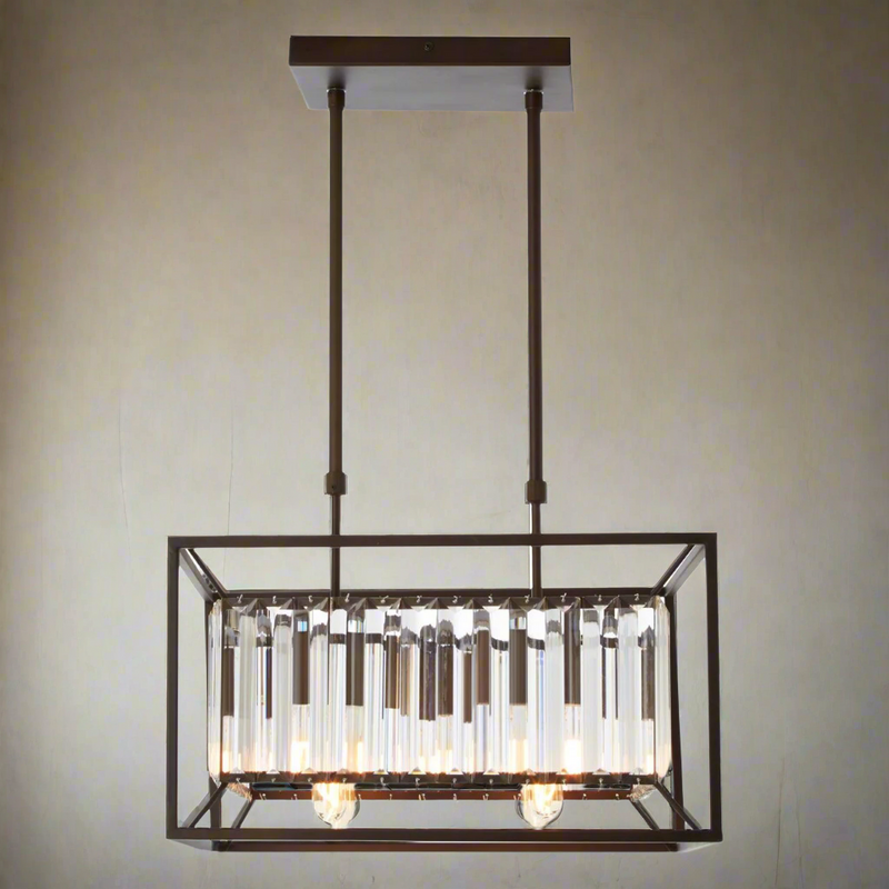 Rectangular industrial caged chandelier with clear glass rods and dark metal frame hanging over a modern kitchen ceiling