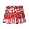 Red pleated cotton lampshade with bold Ikat pattern in red, white and gold tones.