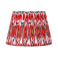 Red pleated cotton lampshade with bold Ikat pattern in red, white and gold tones.
