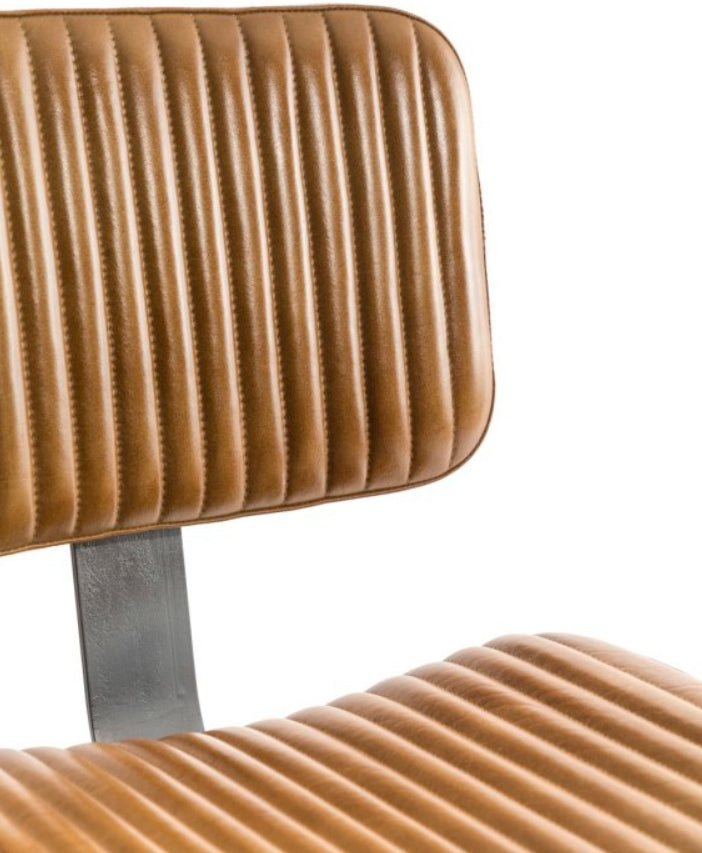 Ribbed tan leather dining chair with slim black iron legs and a contoured seat and back.