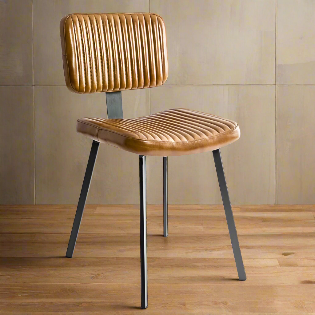 Ribbed tan leather dining chair with slim black iron legs and a contoured seat and back.