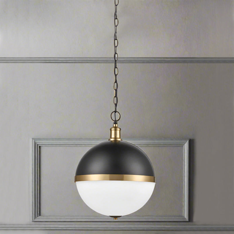Round dark metal and opaque glass pendant with gilt accent to the centre on a gilt mount and chain. A really unusual pendant light, exceptional style and perfect as a kitchen island light. 