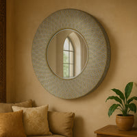 Round wall mirror with Moroccan-inspired antique gold patterned frame. Perfect for hallways and living rooms