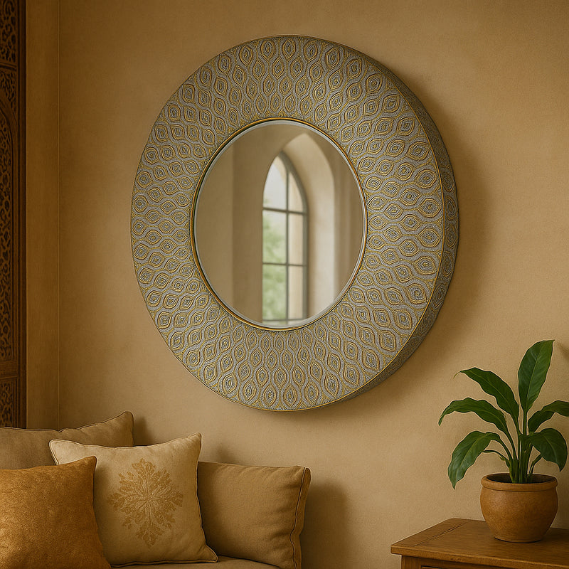 Round wall mirror with Moroccan-inspired antique gold patterned frame. Perfect for hallways and living rooms