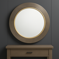 Simple round brushed bronze mirror over a country console table