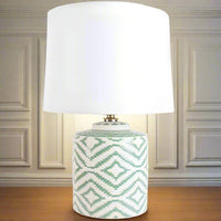 On a wooden table, against a grey paneled wall, in a living room.