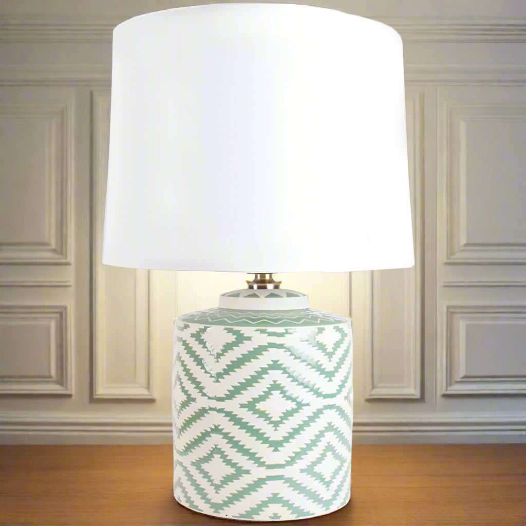 On a wooden table, against a grey paneled wall, in a living room.