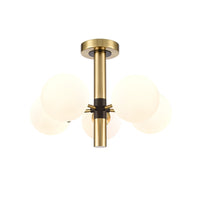 Semi Flush ceiling pendant with 5 opaque globe lights set on a brushed gold frame with central black accents.