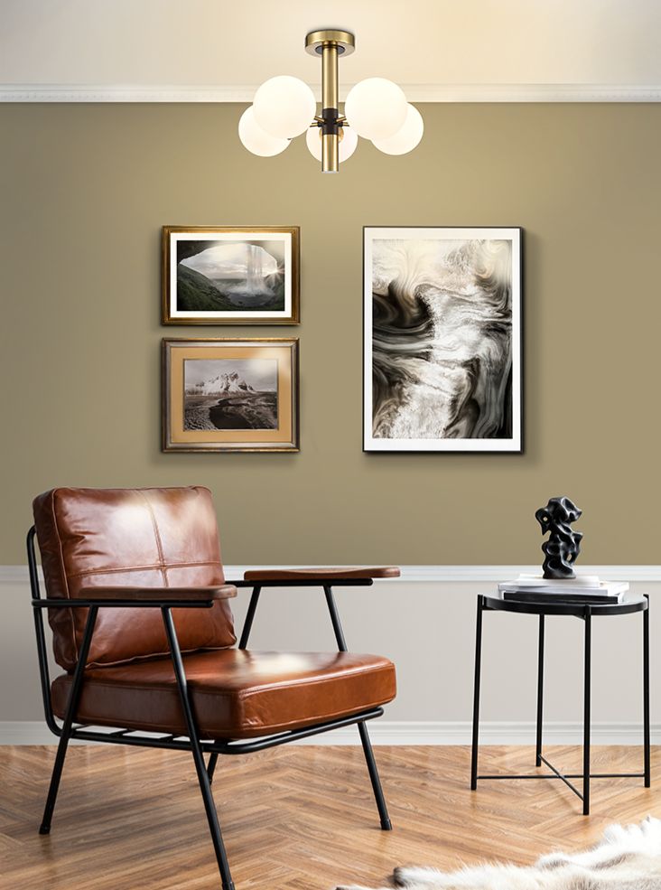 Semi flush ceiling light with five opaque globe shades on a brushed gold frame with black accents