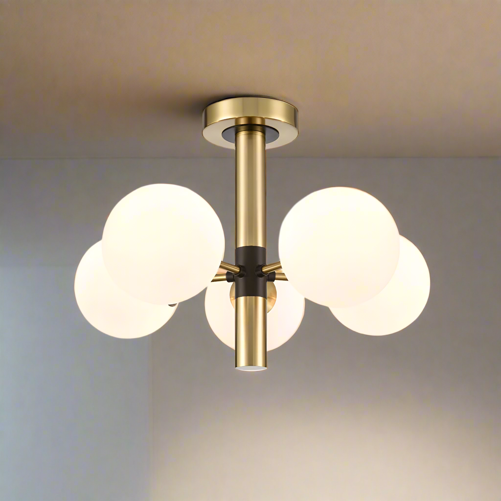 Semi flush globe ceiling pendant with five opaque globe lights set on a brushed gold frame with central black accents.