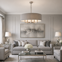 Large, grey linen pendant in a silver grey sitting sitting room setting with sofa, tables and lighting.