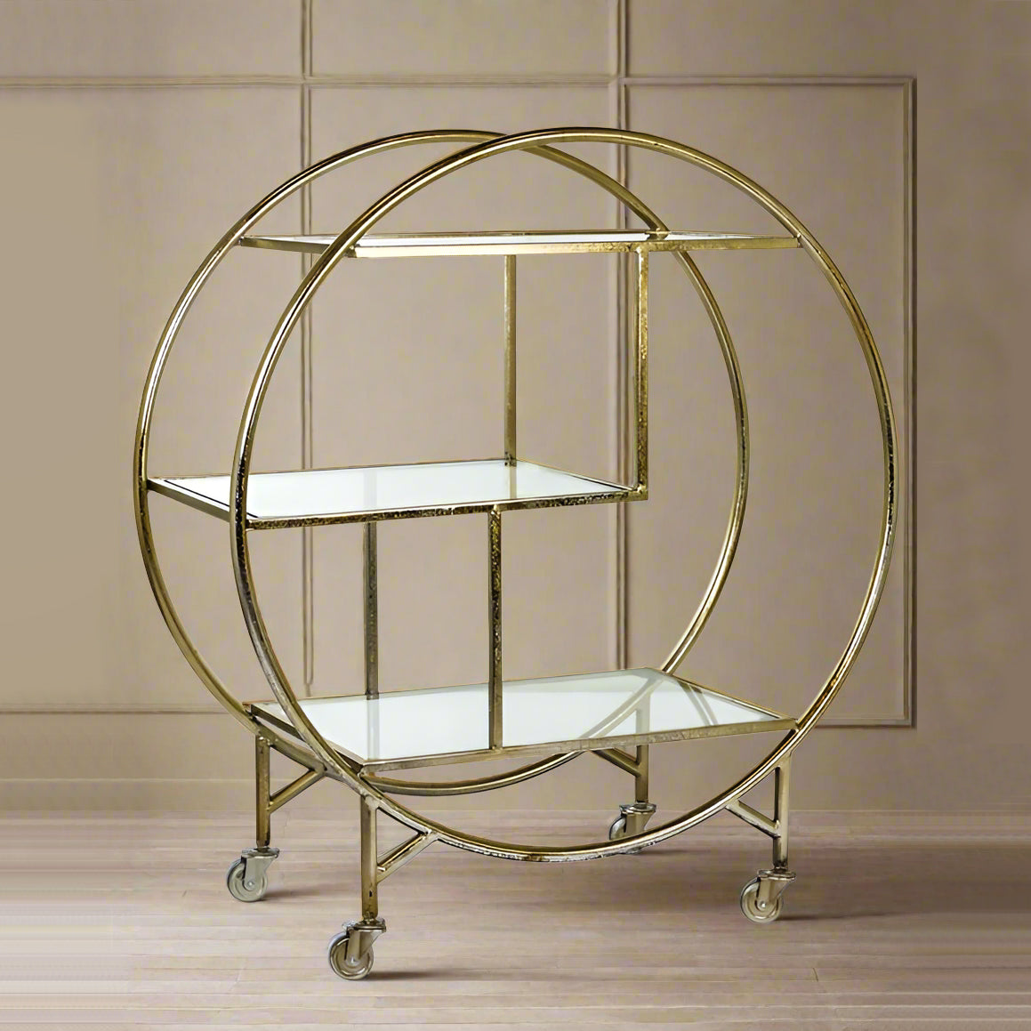 A silver metal drinks trolley with mirrored shelves and wheels for easy mobility, featuring a classic art deco style.