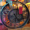 Moving Cog Clock Silver 55 cm displayed in a shop window with decorative non-moving cogs and a reduced price tag of £85. Industrial-style wall decor.