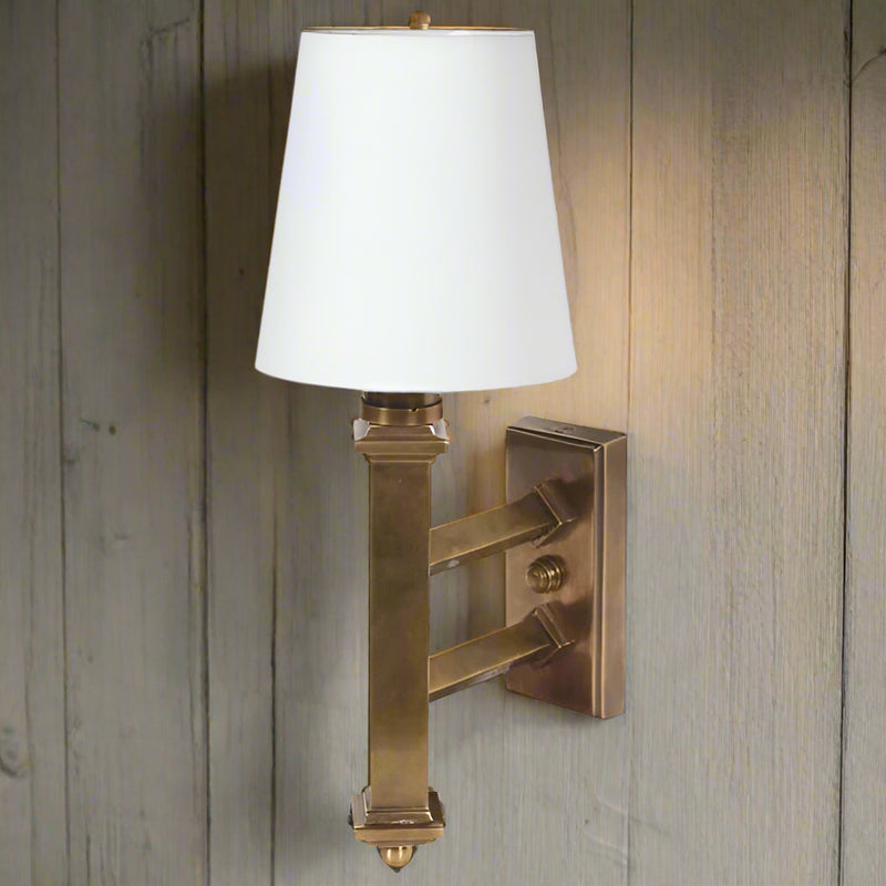 Single antique brass wall light with white linen shade. A great solid, vintage look.&nbsp; A sturdy wall light, perfect for a bedroom, hallway or living room.&nbsp; Would work well in a classic country home interior.&nbsp; These wall lights are the&nbsp; perfect addition to any space allowing a warm ember glow through the white linen shade to illuminate the room. Blending classic elegance with a warm understated vintage style, exceptional lighting for exceptional interiors.