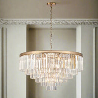 This six-tier crystal chandelier is designed to make a bold, unforgettable statement in any room. Its polished gold band supports cascading layers of prism-cut crystals