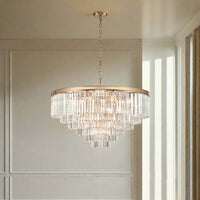 This six-tier crystal chandelier is designed to make a bold, unforgettable statement in any room. Its polished gold band supports cascading layers of prism-cut crystals