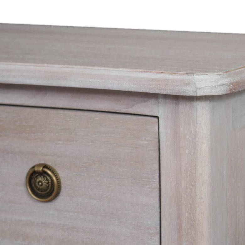 Close-up of a soft off white wooden three drawer chest with brass knob, showcasing smooth finish and detailed craftsmanship.