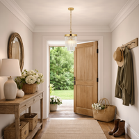 Nestled entryway with a wooden console table, floral arrangements, and a gold pendant light.