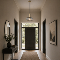 Smoked glass pendant at the front of a luxurious hallway, in front of a door surrounded by glass.
