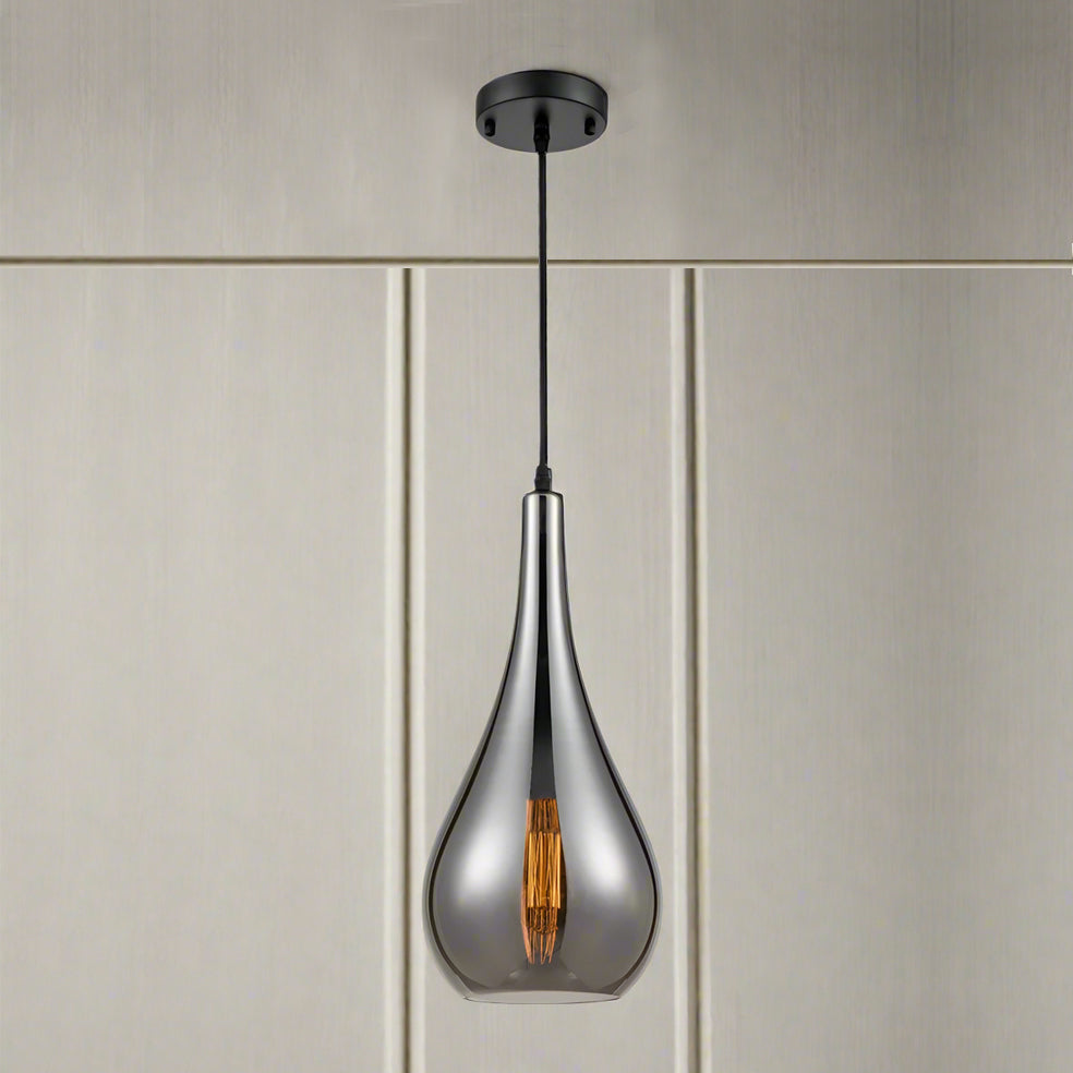smoked glass pendant light with slim teardrop shape and angled cut glass hanging from a dark ceiling rose