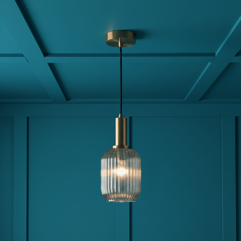 Smoked glass and gilt metal fitting in a grey paneled room.