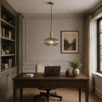 Smoked pendant in a home office setting over a desk with bookshelves. 