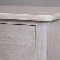 A solid hardwood three draw bedside table made from bleached mahogeny wood with ash veneers in a white wash finish. 