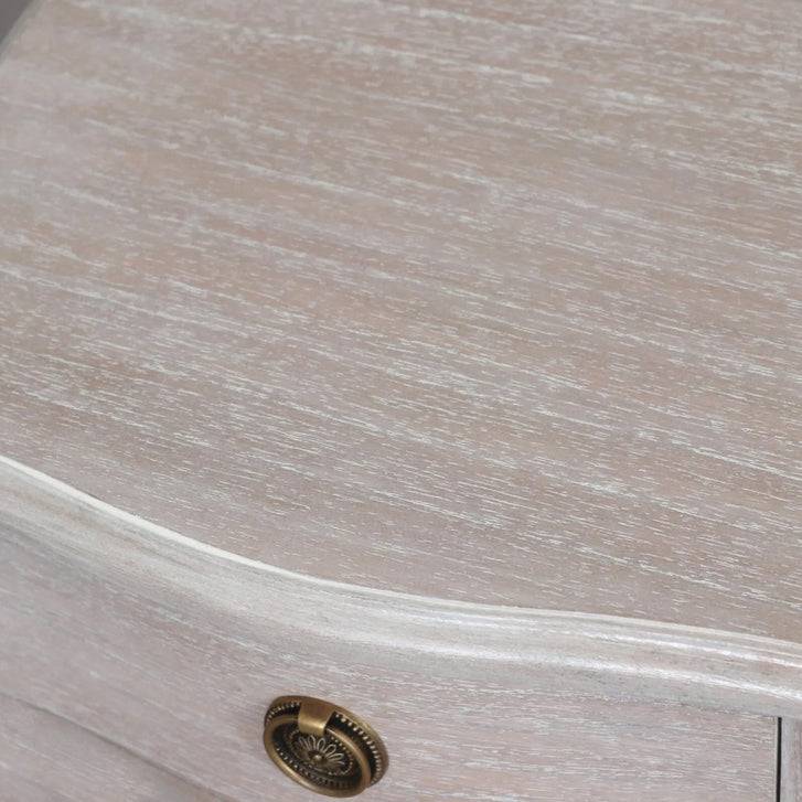 A solid hardwood three draw bedside table made from bleached mahogeny wood with ash veneers in a white wash finish. 