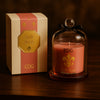 Soft Rose scented candle in pink glass with gold emblem and clear cloche, presented in a matching pink and gold gift box.