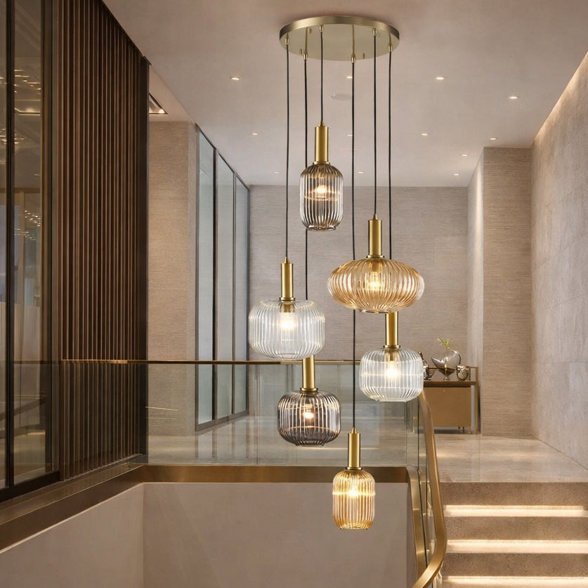Six ribbed glass pendant hanging in a contemporary stairwell in a modern setting.