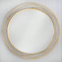 A luxury brushed brass gilt gold mirror that brings high impact &amp; understated simplicity with a contemporary yet antique feel. This swirl circular mirror looks amazing in hallways, living rooms, bedrooms or bathrooms - any room that could with a light touch of elegant spark. 