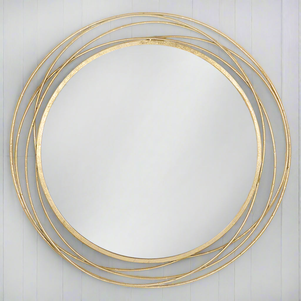 A luxury brushed brass gilt gold mirror that brings high impact &amp; understated simplicity with a contemporary yet antique feel. This swirl circular mirror looks amazing in hallways, living rooms, bedrooms or bathrooms - any room that could with a light touch of elegant spark. 