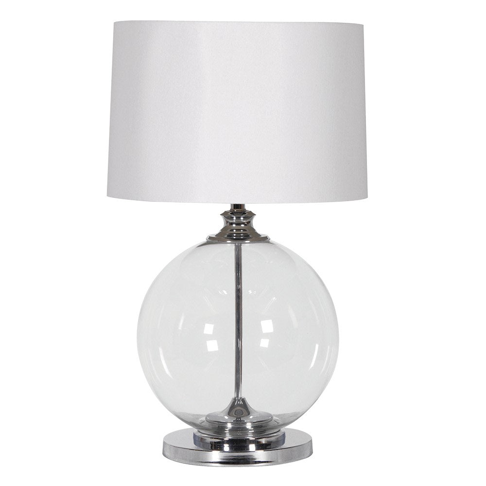 An elegant, round glass based table lamp with a white shade. The glass set into a nickel metal base and neck.