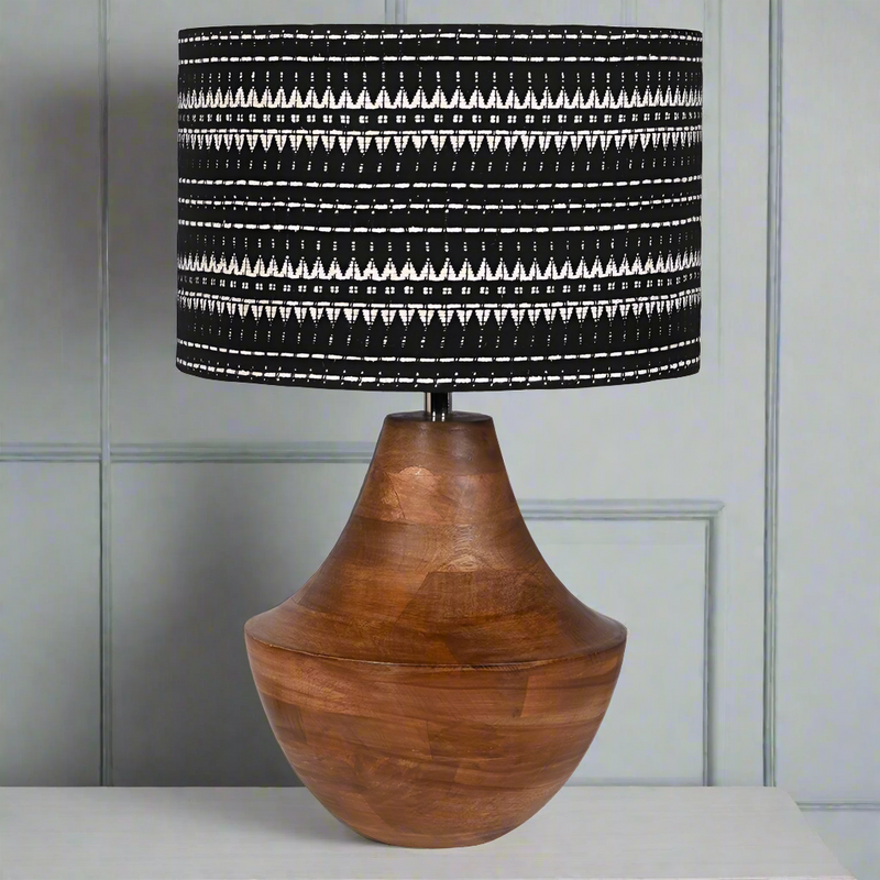 Absolutely beautiful wooden lamp with a distinctive black and white woven shade. A statement lamp if ever the was one. A really large base set off perfectly by the intricate handwoven shade, great on a sideboard or large console table. The black and white colour of the shade compares beautifully with the deep patina of the wood on the base.