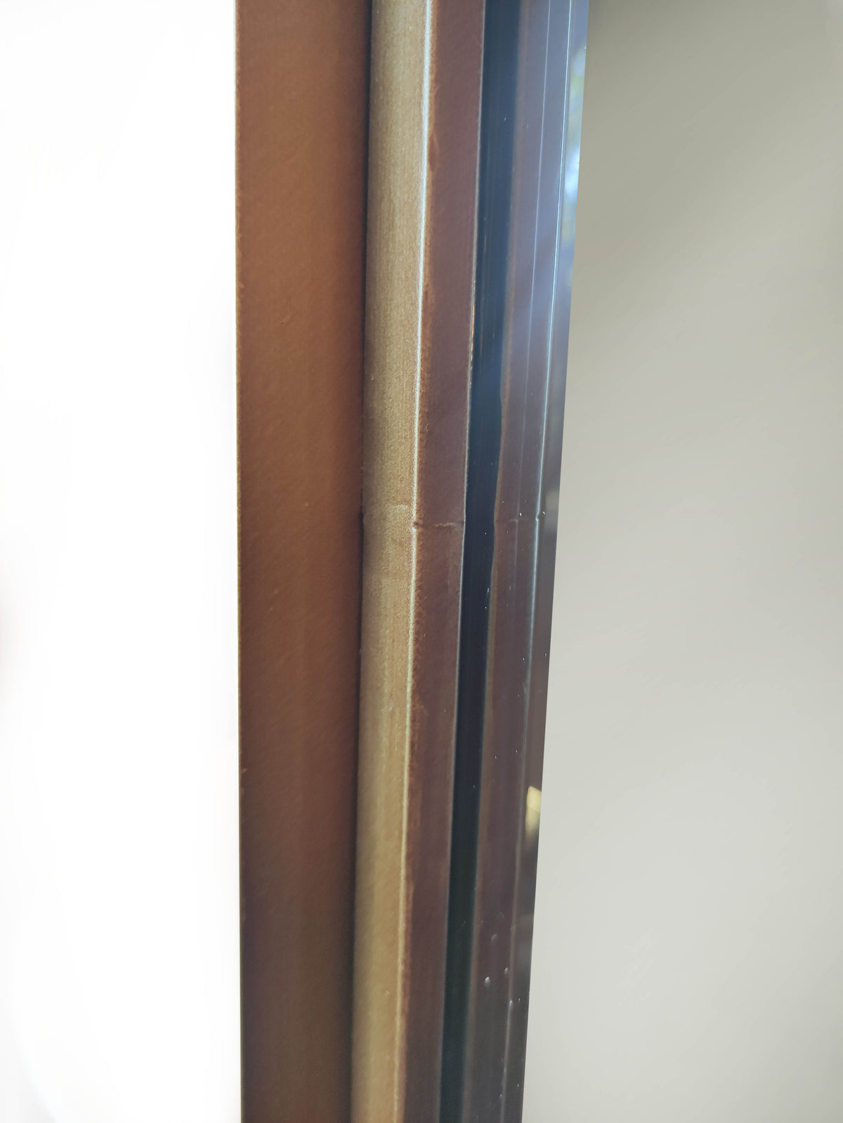  bronze metal frame detail on arched mirror
